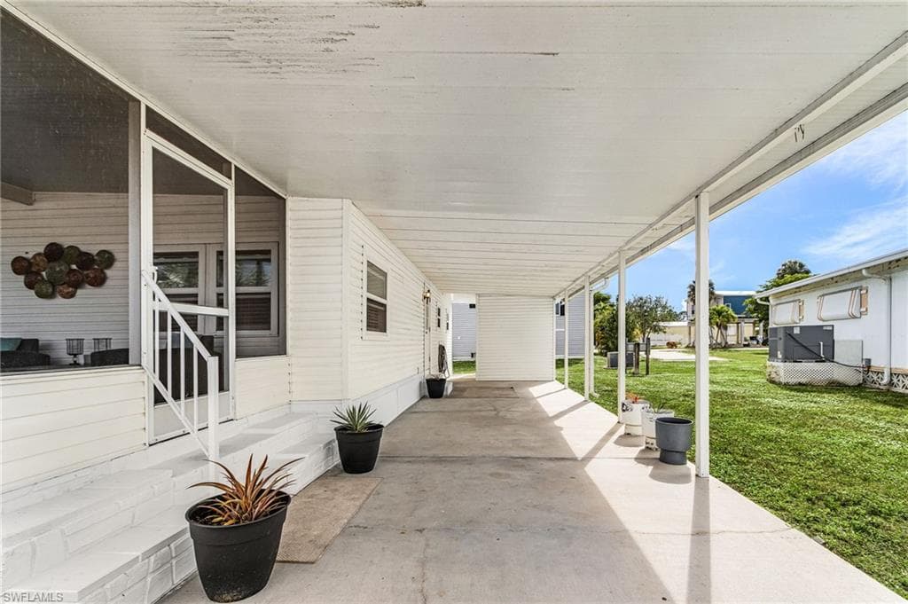 Expansive covered patio featuring a concrete surface and a partial screen enclosure