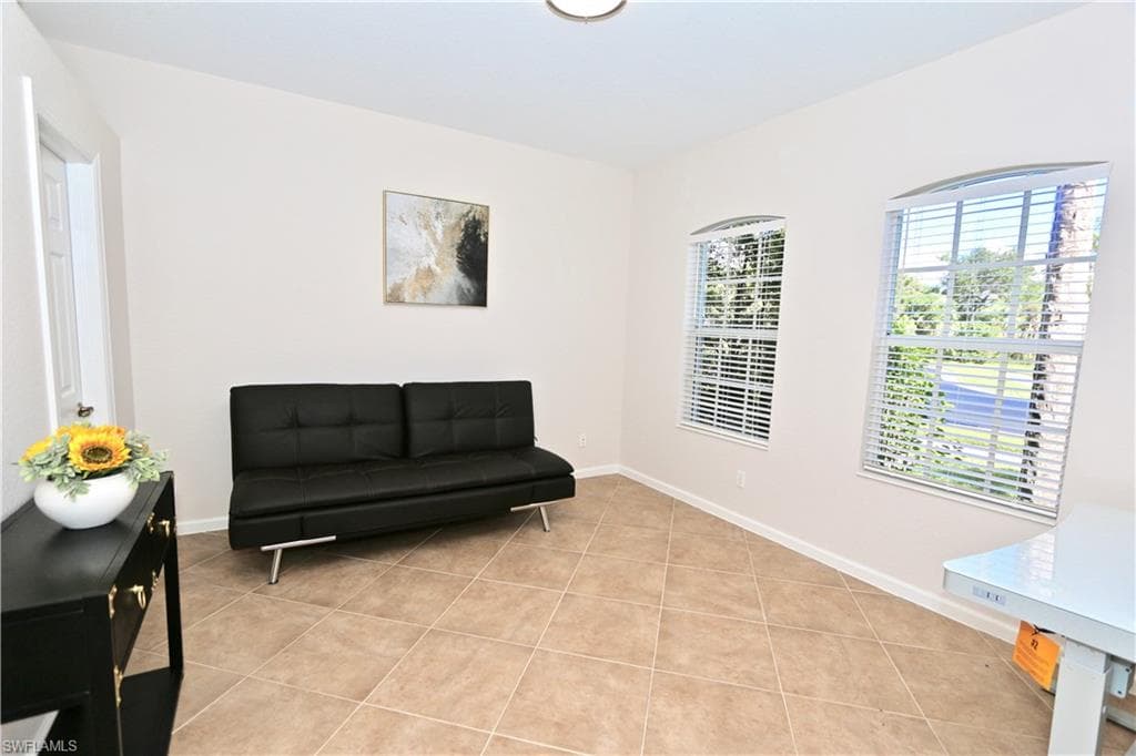 Neutral tile flooring extending throughout the room