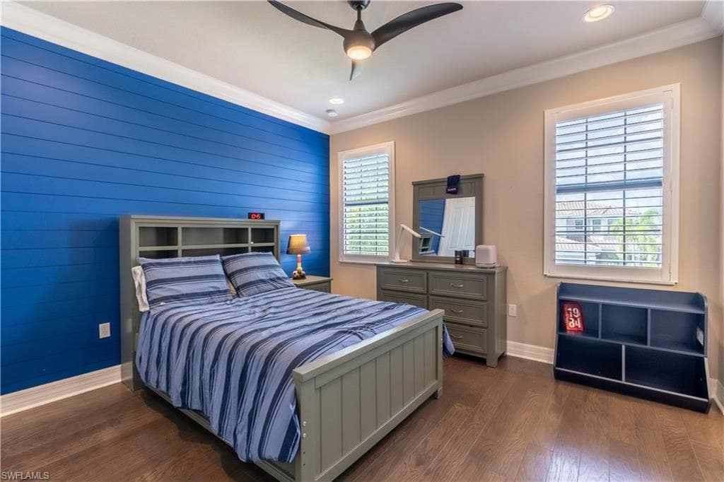 Spacious room featuring wood-finish flooring and a distinctive blue shiplap accent wall