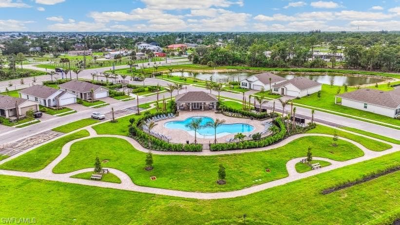 Aerial view of the community's amenities, featuring a swimming pool, a covered cabana, and manicured green spaces with walking paths