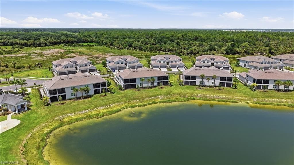 Waterfront multifamily community featuring multiple buildings with screened lanais and a lush, undeveloped backdrop