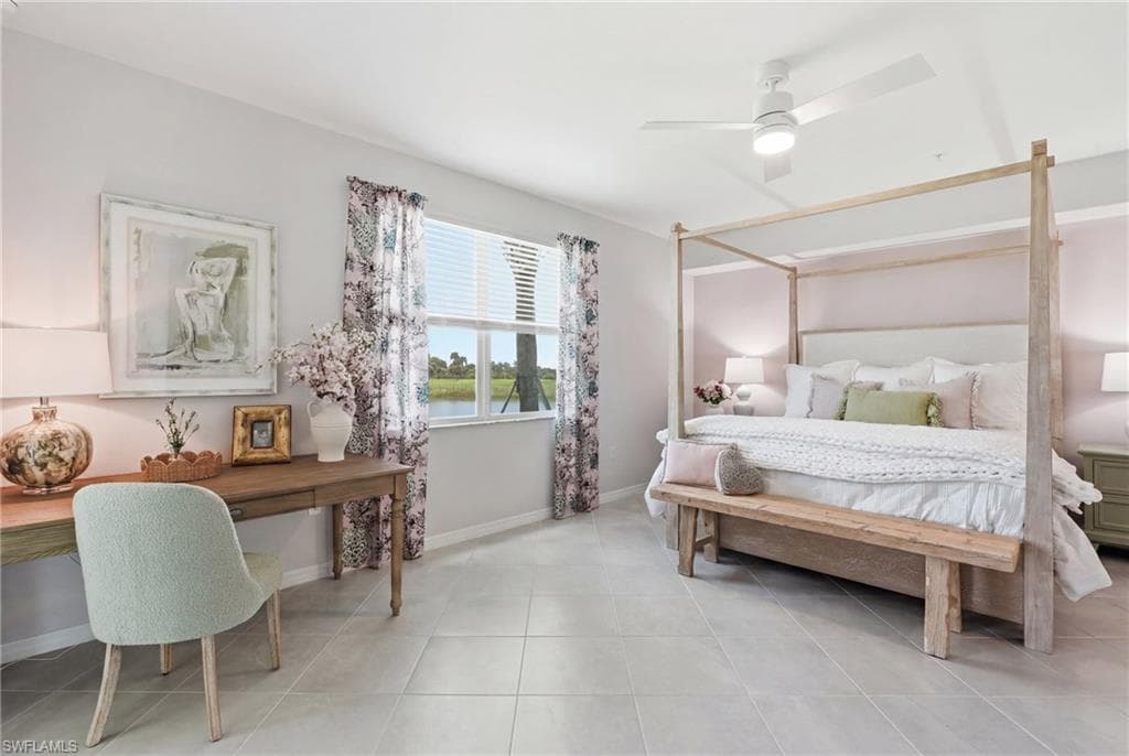 Spacious room featuring tile flooring, a large window with blinds, and a ceiling fan with integrated lighting