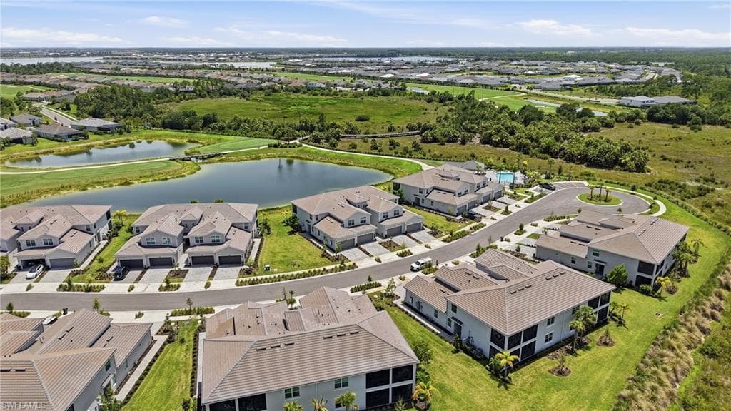 Aerial perspective showcasing a residential community with multiple buildings featuring tiled roofs