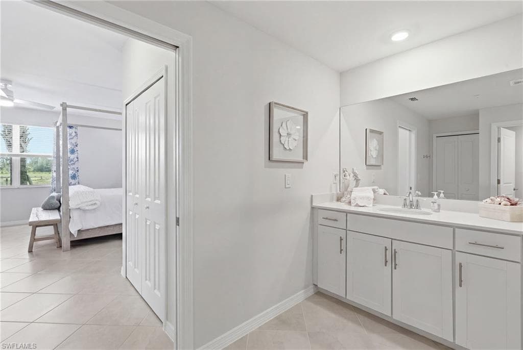 Double vanity with white cabinetry and chrome fixtures, featuring ample counter space and an integrated sink