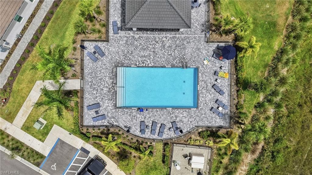 Rectangular swimming pool with integrated steps, surrounded by a paver deck