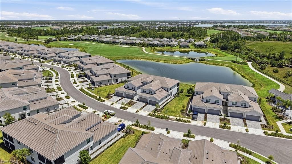 Aerial perspective showcasing a residential community with manicured landscaping and water features