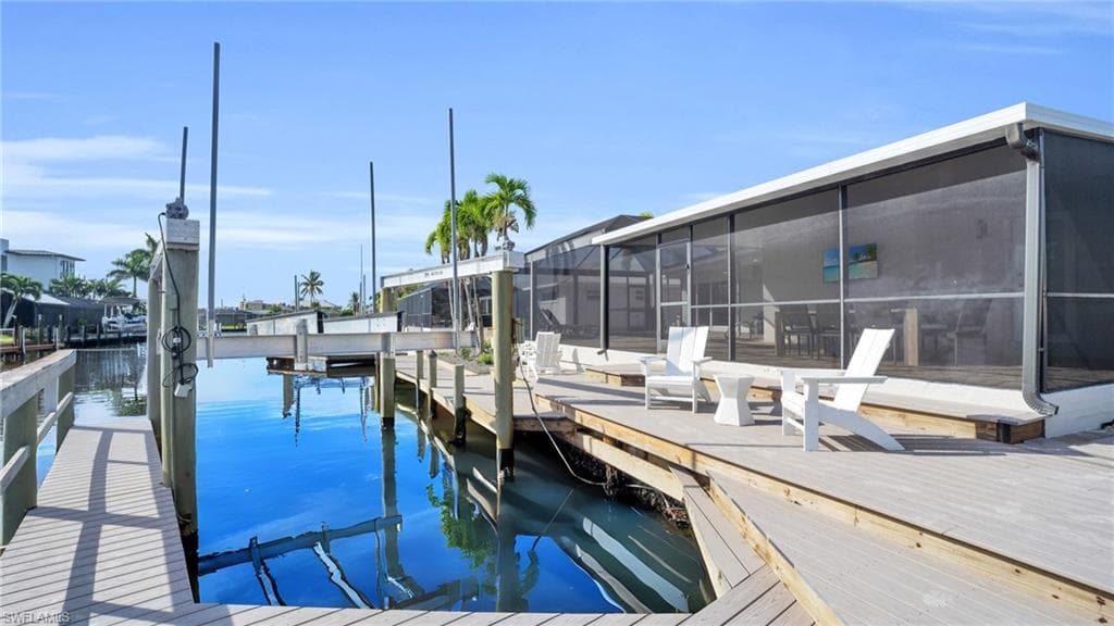 Dock area featuring composite material decking, captains walk dock and 20,000 pound boat lift. VIRTUALLY ENHANCED -