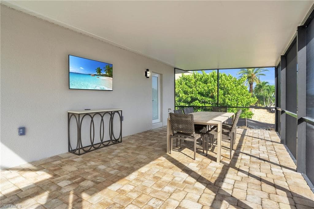 Even more covered screened in pool area off to the side to relax and entertain right along the canal.