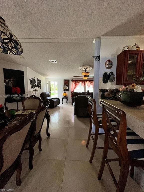 Expansive interior featuring tile flooring, a breakfast bar, and an open-concept layout
