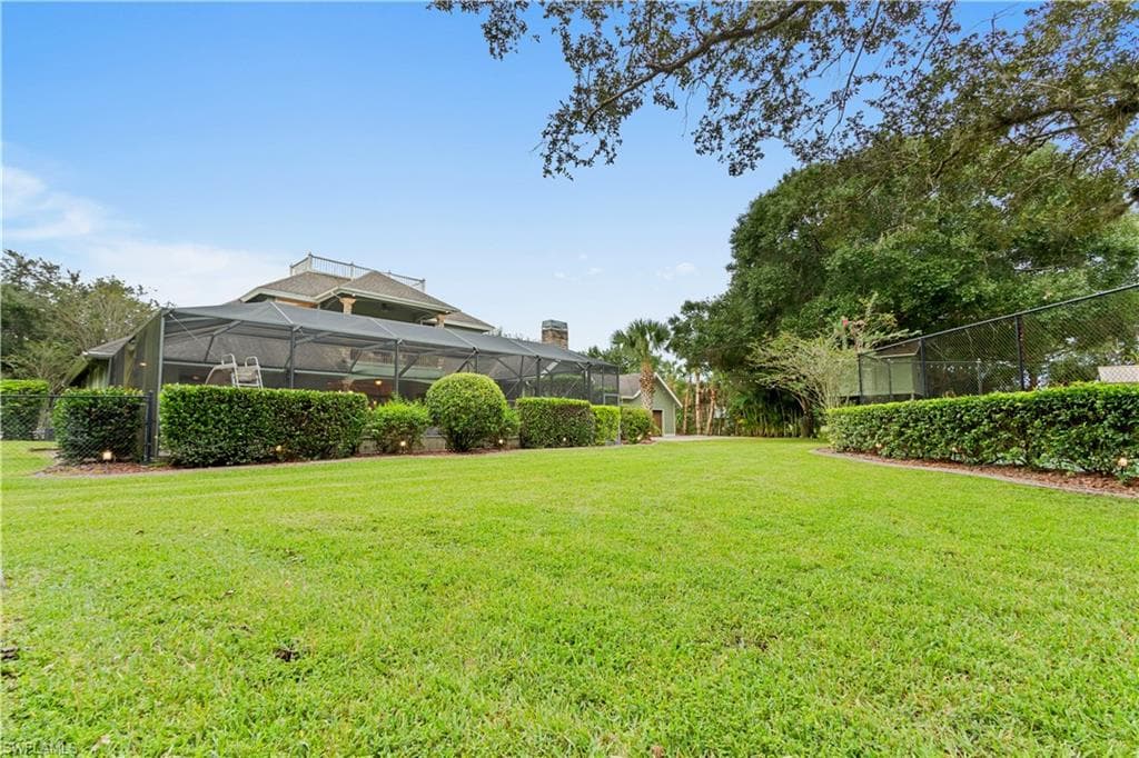 Expansive grassy lawn bordered by manicured hedges