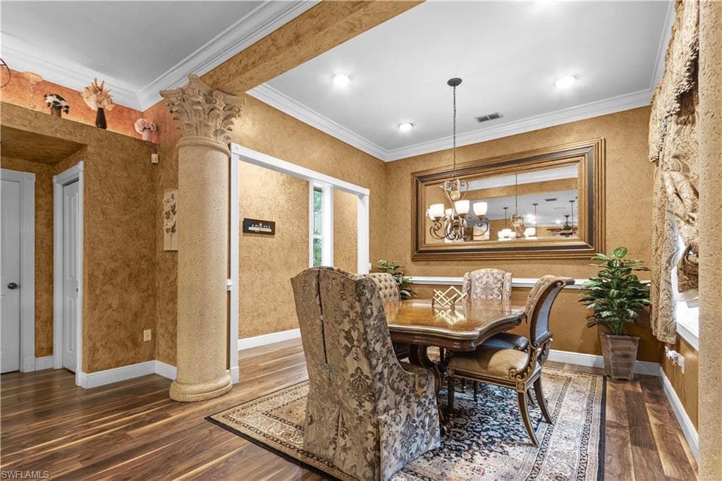 Dining area featuring wood-finish flooring, textured wall finishes, and white crown molding