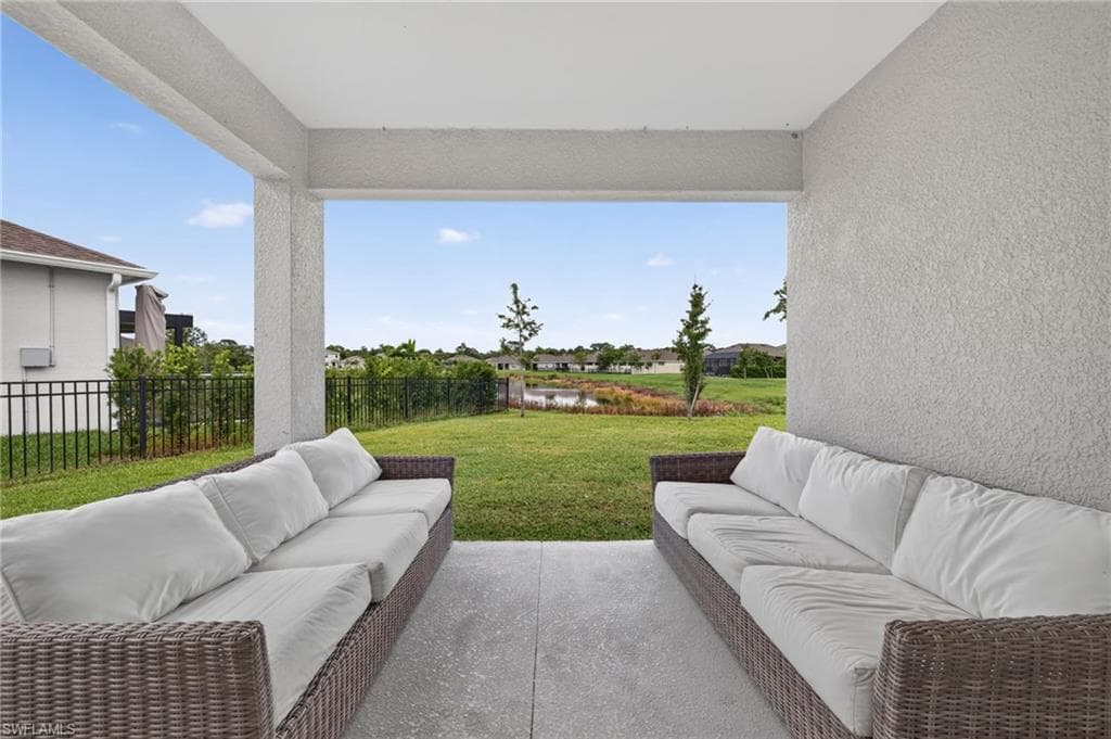 Covered patio featuring a concrete slab and a stucco finish