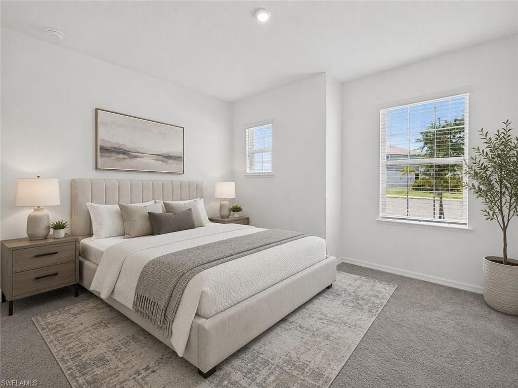 Bright bedroom featuring two windows with horizontal blinds, plush carpeting, a recessed ceiling light, and white painted walls, Virtually Staged Bedroom 1