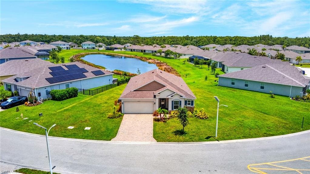 Single-story residence on a cul-de-sac lot, featuring a paver driveway and a two-car garage