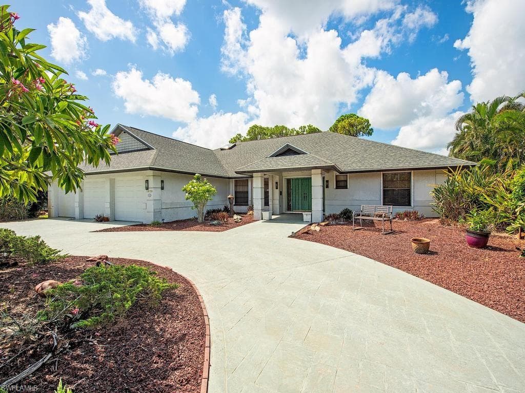 Front elevation and circular driveway with 3-car garage