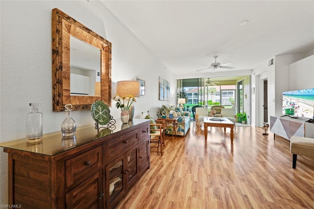 Living room featuring light hardwood / wood-style floors and ceiling fan