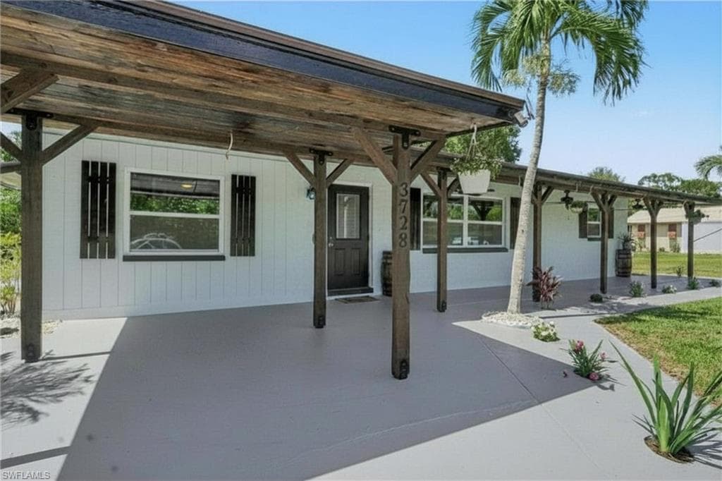 3728 Gasparilla St - Carport and Porch with gorgeous coastal plank wood ceiling crowns the porch boasting 3 ceiling fans and LED lighting added for enjoyment.