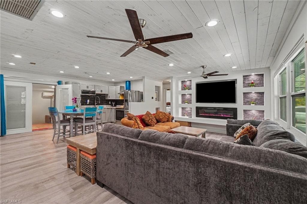 Main house - expansive great room is highlighted by a custom coastal plank wood ceiling, delivering the perfect blend of sophistication and seaside style.