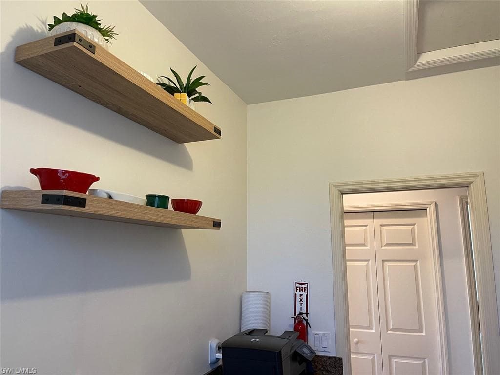 Half Bathroom with Lots of Cabinetry, Countertops, Wash Sink, Full Sized Washer and Dryer.