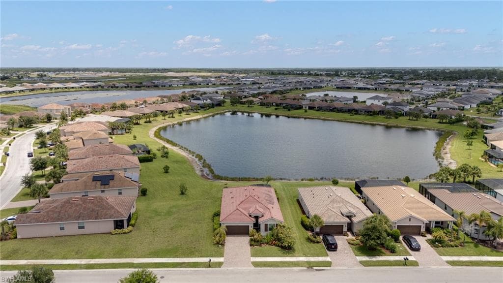 Residential community featuring multiple single-story homes with paver driveways