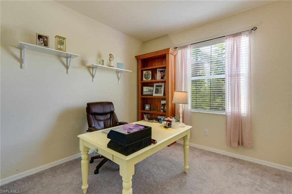 Carpeted room with a double-hung window featuring horizontal blinds