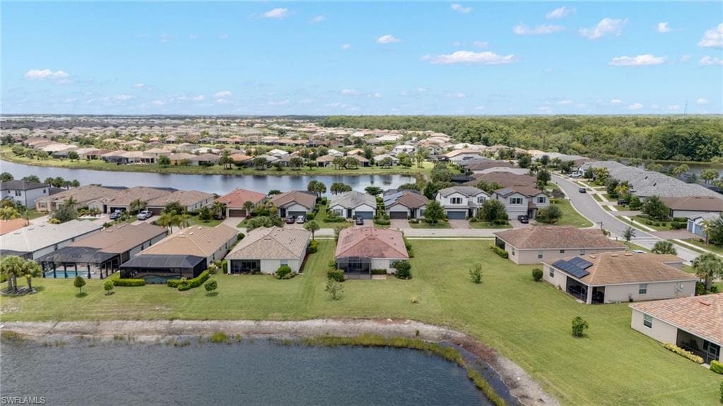 Residential community featuring numerous single-family homes, many with screened-in lanais and direct water frontage
