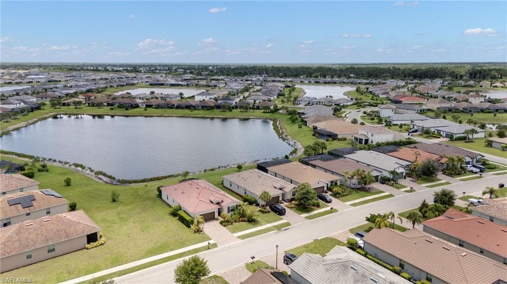 Expansive community featuring multiple residential properties with diverse roof styles, each with manicured lawns
