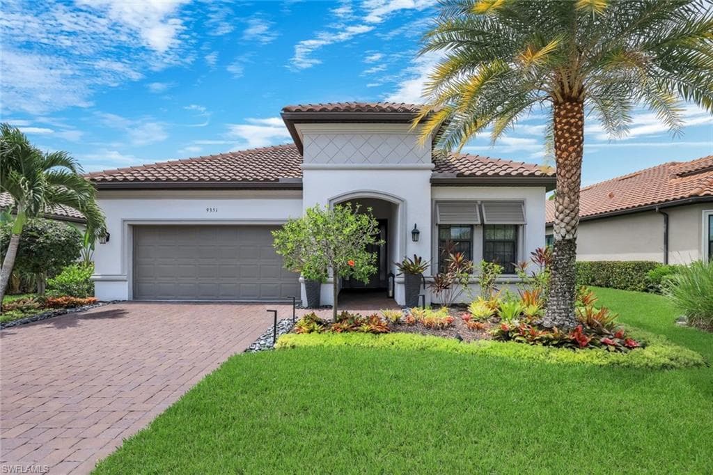 Mediterranean-inspired exterior with a tile roof and stucco finish