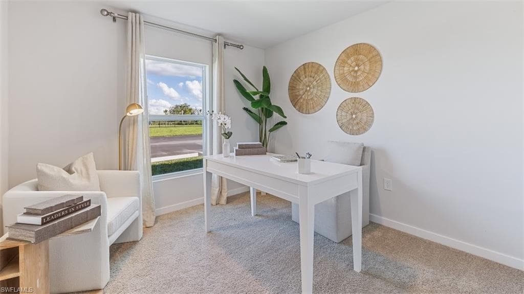 Model home. Office featuring light carpet and baseboards
