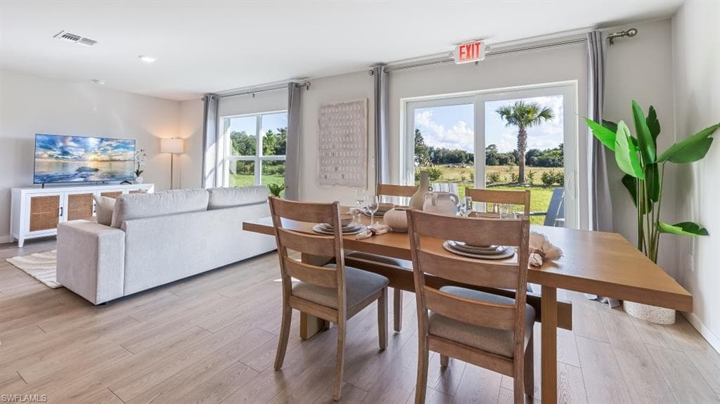 Model home. Dining area featuring light wood-type flooring
