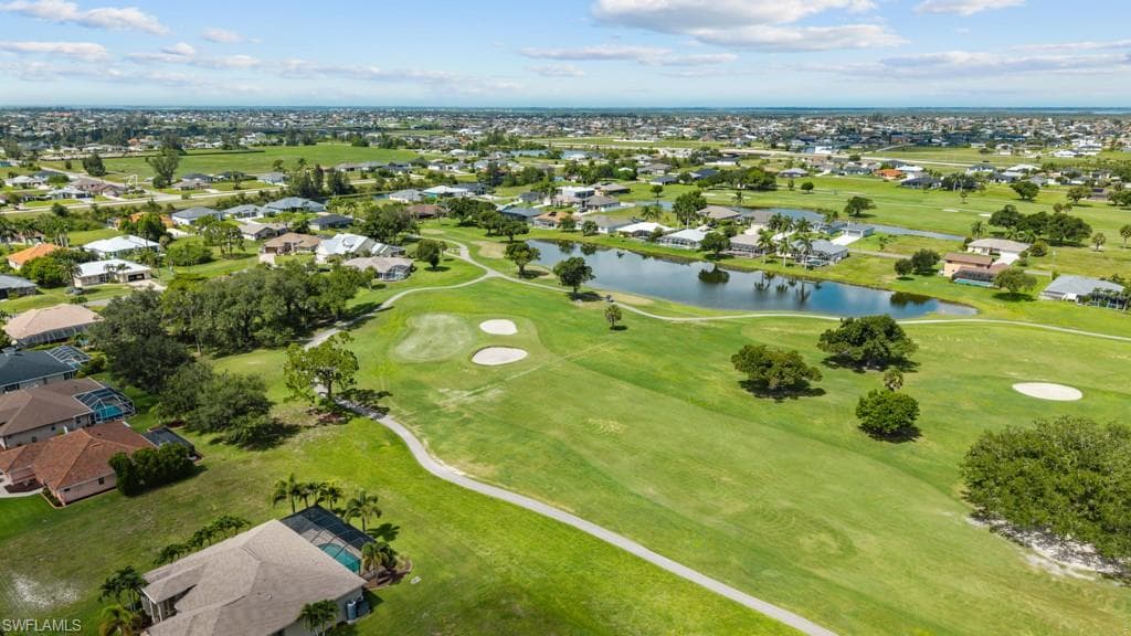 Expansive golf course setting featuring manicured greens, sand traps, and mature trees