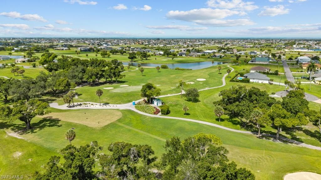 Expansive golf course landscape featuring a manicured green, strategically placed sand traps, and mature trees