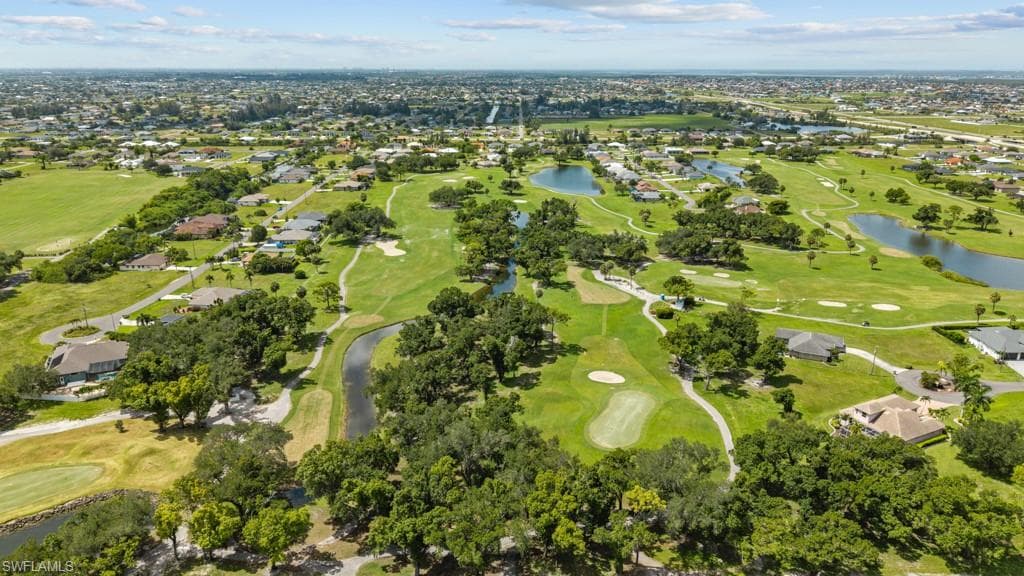 Expansive golf course community featuring manicured greens, mature trees, and multiple water features