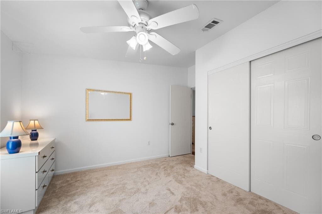 Bedroom with neutral carpet flooring and white walls