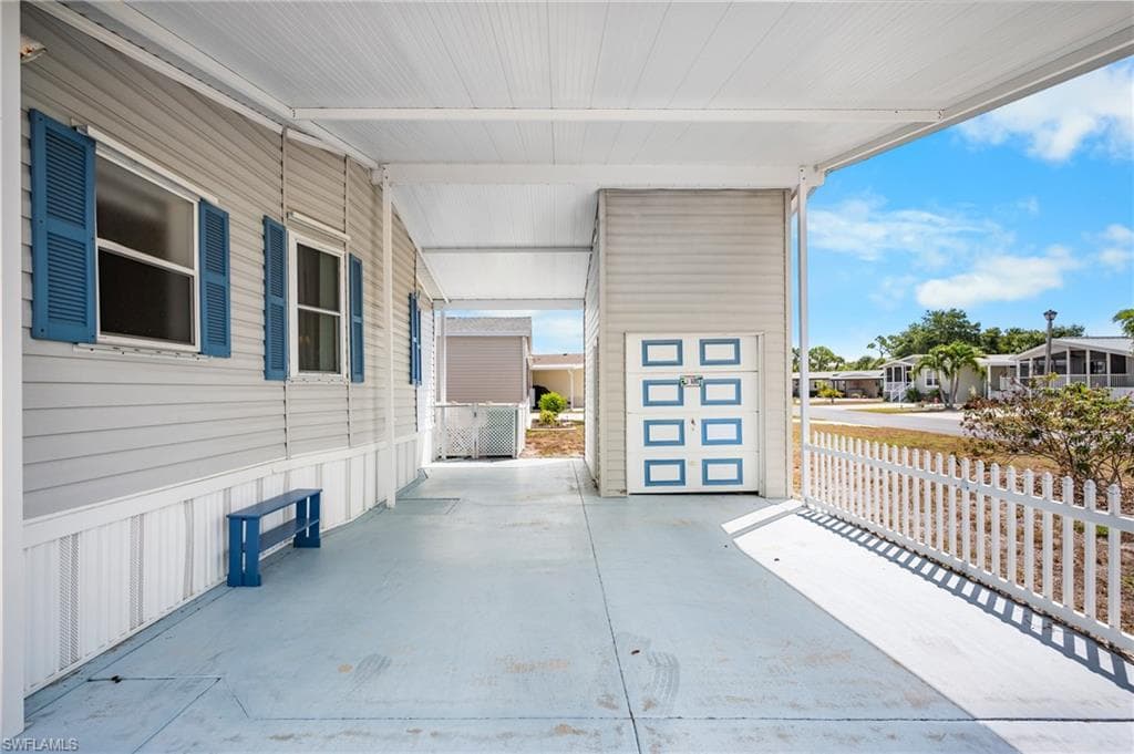 Expansive covered carport with light gray concrete flooring