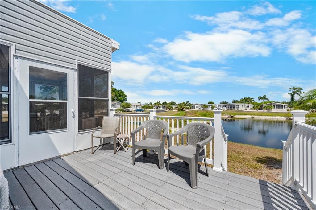 Outdoor deck with water feature, white railing, and exterior siding