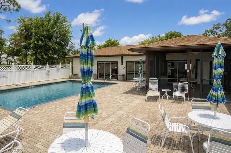 Outdoor swimming pool with integrated steps, surrounded by a paver patio
