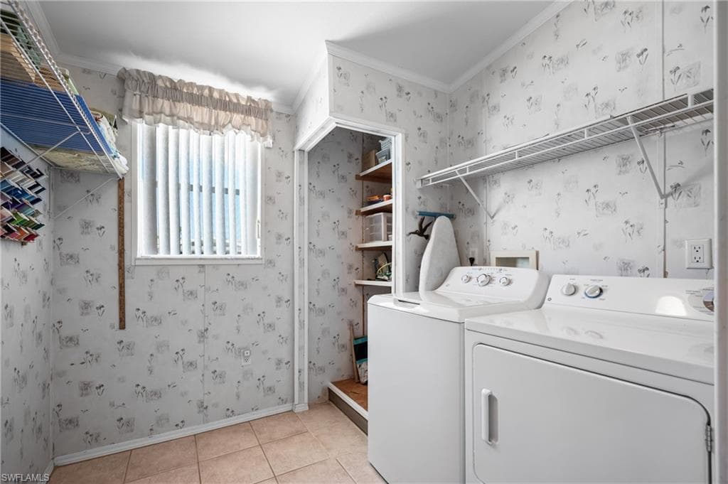 Laundry area featuring a window with vertical blinds, tile flooring, built-in shelving, and a dedicated storage nook