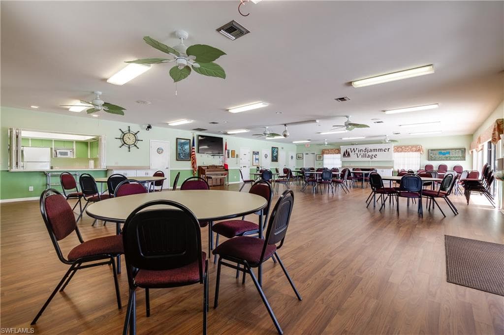 Spacious common area featuring wood-finish flooring, recessed lighting, and multiple ceiling fans