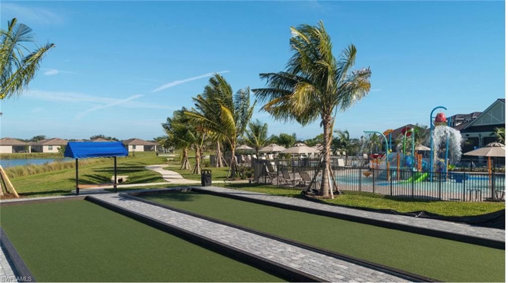 Surrounding community with fence and a yard