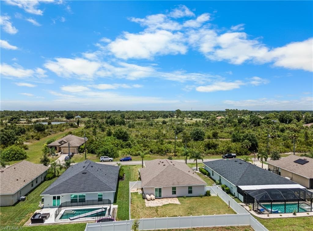 Aerial perspective showcasing multiple homes with private pools