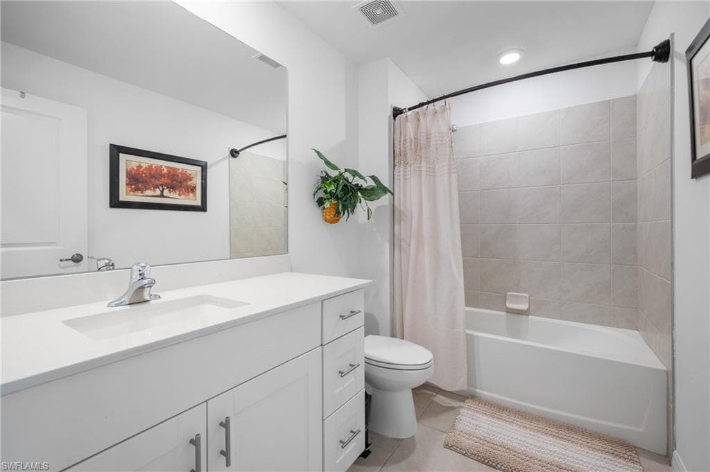 Modern bathroom featuring a white vanity with an integrated sink and chrome faucet