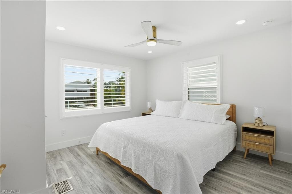 Bedroom with ceiling fan, light wood-type flooring, and recessed lighting - Virtually Edited Image