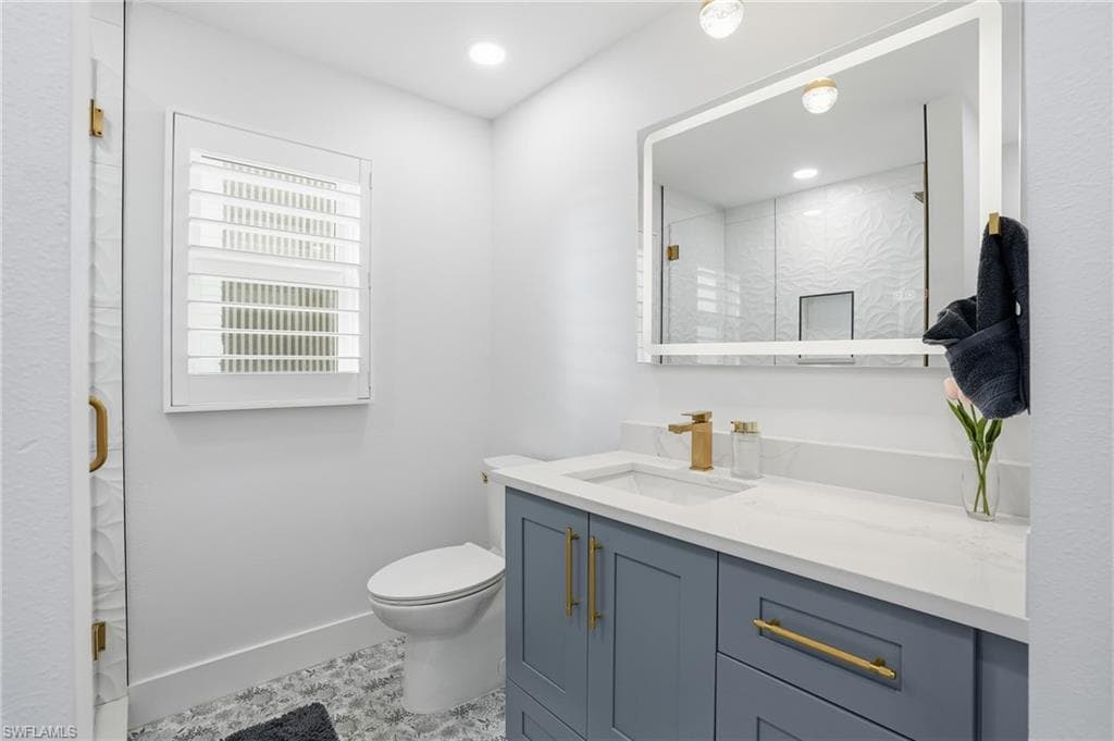 Bathroom featuring vanity, a shower stall, and recessed lighting - Virtually Edited Image