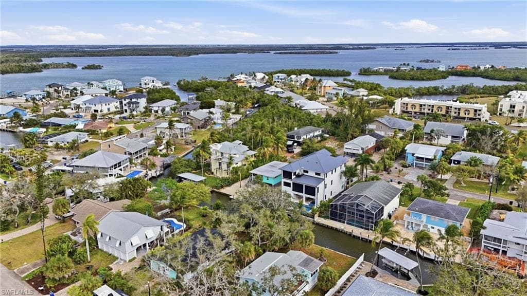 View of property location with a nearby body of water and nearby suburban area
