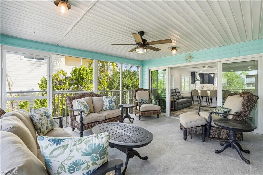 Sunroom with an outdoor hangout area and ceiling fan - Virtually Edited Image