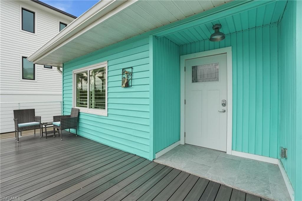 Property entrance featuring a wooden deck - Virtually Edited Image