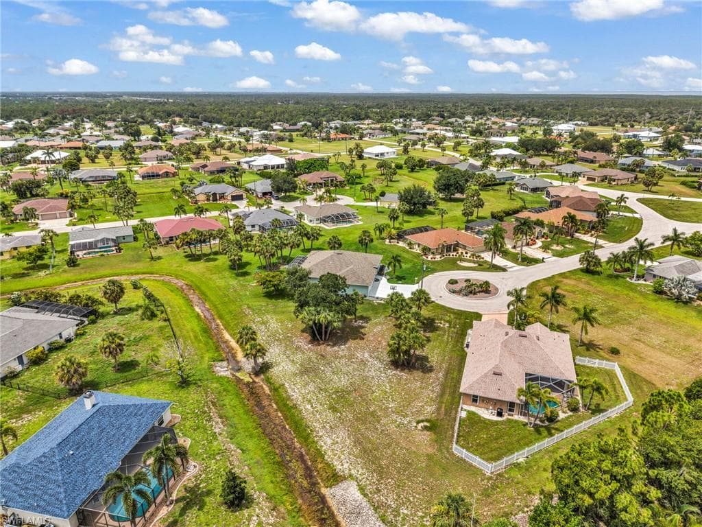 Expansive residential landscape featuring numerous single-story homes, individual swimming pools, and mature palm trees
