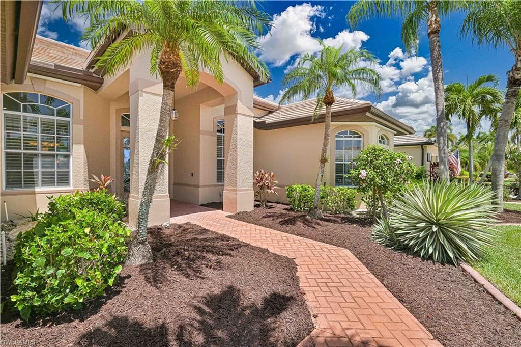 Inviting stucco exterior with a tiled roof and arched windows