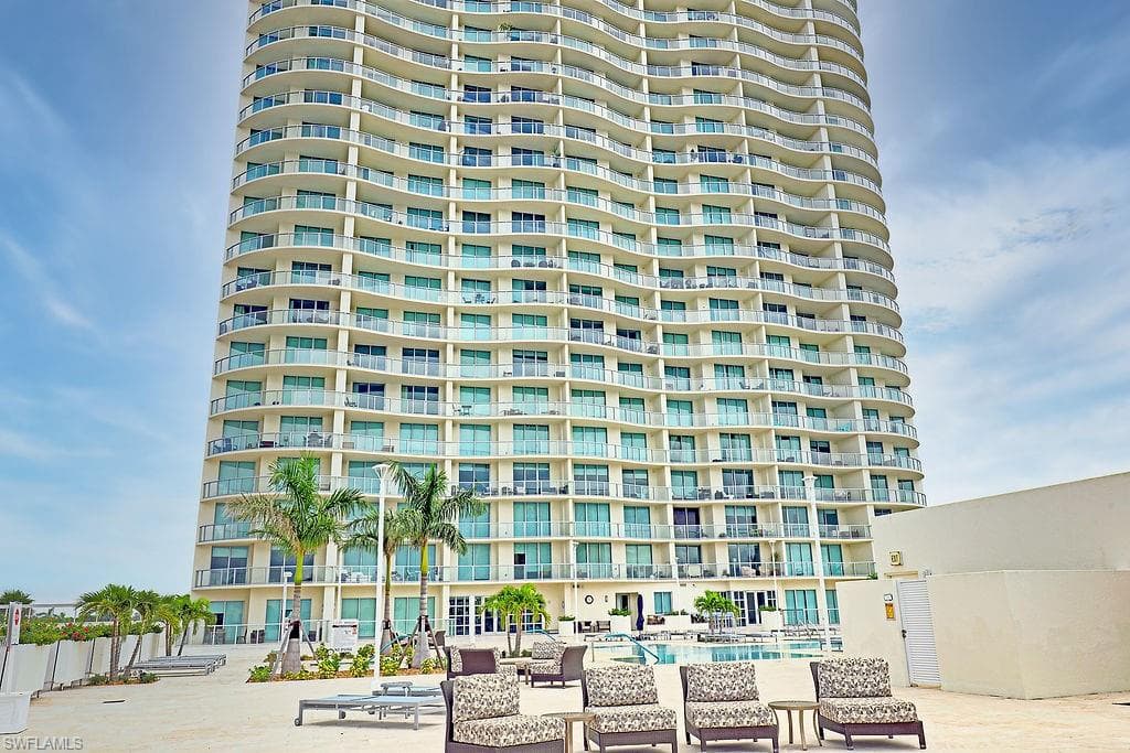 High-rise building with a curved façade and multiple private balconies